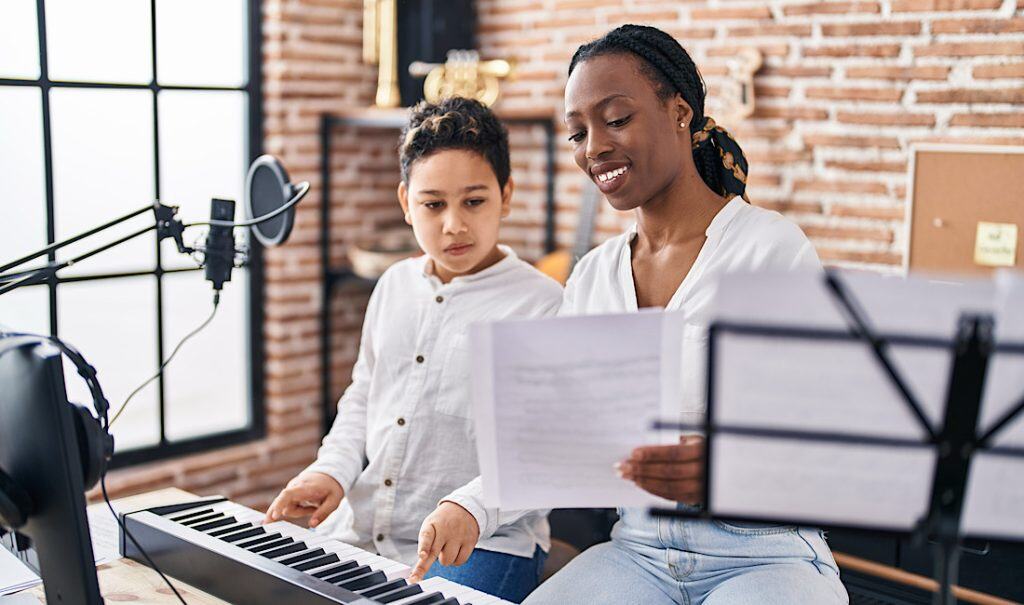 Personalized music lessons with young boy and adult woman.