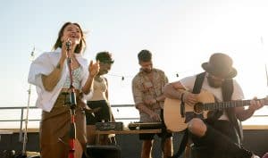 Modern music band of singer and guitarist performing at rooftop party or concert in Omaha, NE.